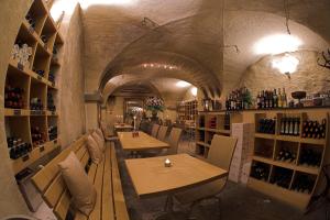 a restaurant with tables and chairs and wine bottles at Hotel Hirschen in Zürich