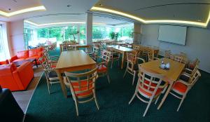 a dining room with tables and chairs in a restaurant at Silesia Golf Resort Kravaře in Kravaře