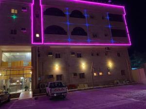 a building with purple lights on the side of it at Al Fanar Al Alamaya 3- Hay'aa Malakeya entrance in Yanbu
