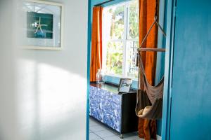a bathroom with a window and a curtain at Numero Uno Beach Apartments in San Juan