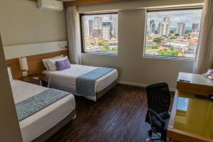 Letto o letti in una camera di Quality Faria Lima