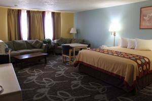 a hotel room with a bed and a couch at Super 8 by Wyndham Nephi in Nephi