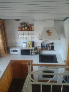 a small kitchen with a stove and a microwave at Appartment Andrea in Eugendorf