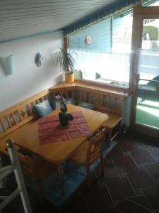 a wooden table and chairs in a room at Appartment Andrea in Eugendorf