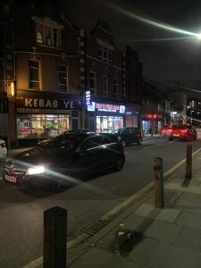 a car parked on a city street at night at Frances St House in London