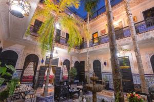 a room with palm trees in a building at Riad Lalla Khiti in Marrakesh