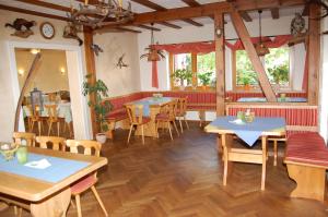 a restaurant with tables and chairs in a room at Landgasthof Jägerstübchen in Neustadt an der Weinstraße