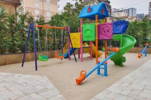 a childrens playground with colorful playground equipment at Luxury Green Apartment in Pristina