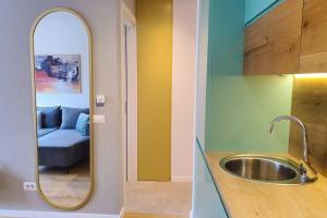 a bathroom with a sink and a mirror at Luxury Green Apartment in Pristina +28 photos