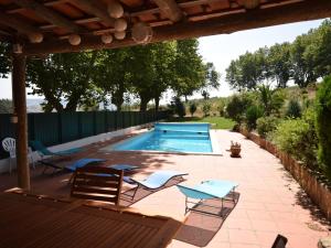 a patio with chairs and a swimming pool at Cozy Villa with Private Swimming Pool in Carreiros