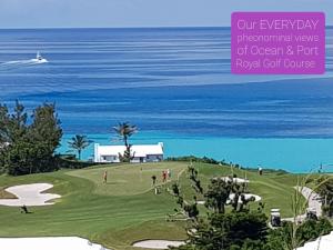 a golf course with the ocean in the background at Bermuda Connections Guest House in Southampton