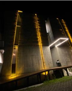 a building with a bench in front of it at night at Water with Candle Homestay in Wujie