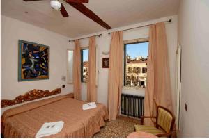 Postel nebo postele na pokoji v ubytování Hotel Antico Capon