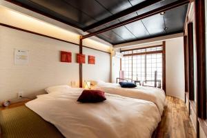 Giường trong phòng chung tại Tabiyado Chirin