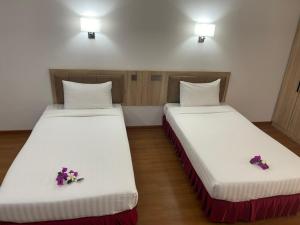 Postel nebo postele na pokoji v ubytování Palmeraiebeach Resort Rayong ปาล์มมาลี บีช รีสอร์ท ระยอง 罗勇棕榈树海滩酒店