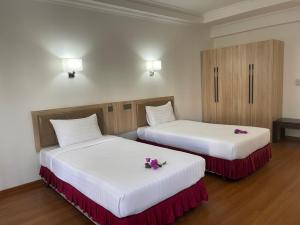 Postel nebo postele na pokoji v ubytování Palmeraiebeach Resort Rayong ปาล์มมาลี บีช รีสอร์ท ระยอง 罗勇棕榈树海滩酒店