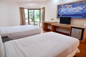 Postel nebo postele na pokoji v ubytování Palmeraiebeach Resort Rayong ปาล์มมาลี บีช รีสอร์ท ระยอง 罗勇棕榈树海滩酒店