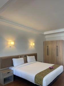 Postel nebo postele na pokoji v ubytování Palmeraiebeach Resort Rayong ปาล์มมาลี บีช รีสอร์ท ระยอง 罗勇棕榈树海滩酒店