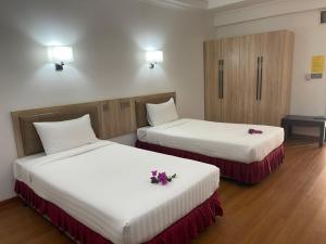 Postel nebo postele na pokoji v ubytování Palmeraiebeach Resort Rayong ปาล์มมาลี บีช รีสอร์ท ระยอง 罗勇棕榈树海滩酒店