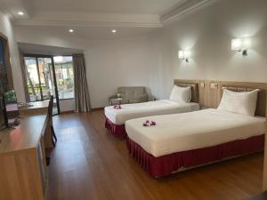 Postel nebo postele na pokoji v ubytování Palmeraiebeach Resort Rayong ปาล์มมาลี บีช รีสอร์ท ระยอง 罗勇棕榈树海滩酒店