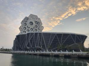 a building on the water next to a body of water at Knock Knock Hostel in Kaohsiung