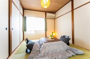 a room with a table and chairs and a window at Takashima Lakeside Resort in Takashima