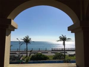 a view of the ocean from a building with an arch at OwlStay The Salt in Hualien City +22 photos