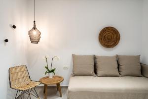 a living room with a couch and a chair at Hippocampus Hotel in Kamari