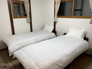 A bed or beds in a room at 富士晴 Guest House