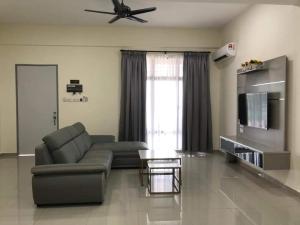 a living room with a couch and a table at KS 80 Homestay (15pax)4R3B ~WiFi~ near Jetty in Kuala Selangor