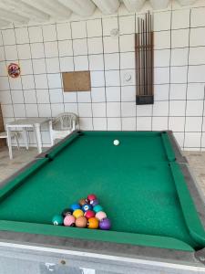 a pool table with a bunch of balls on it at San Marino Hotel in Itanhaém