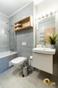 a bathroom with a sink and a toilet and a mirror at Quibio Apart Terrace in Braşov +44 photos