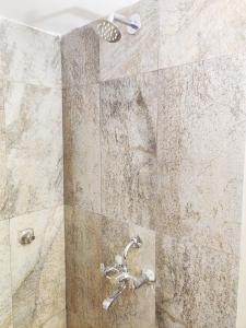 a shower with a faucet in a bathroom at Eros Boutique Hotel in Baga +29 photos