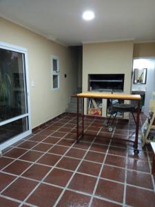 a room with a table and a tiled floor at Departamento Necochea in Necochea