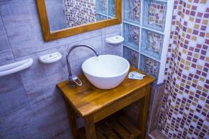 a bathroom with a bowl sink on a wooden table at San Bernardo Aparts in San Bernardo +34 photos