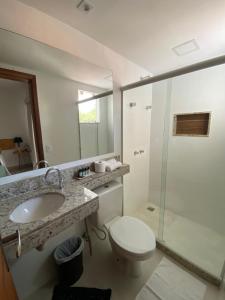 a bathroom with a toilet and a sink and a shower at Pousada Camarote Itaipu in Niterói +72 photos