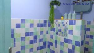 baño con una pared de azulejos de colores y lavamanos en Villa Qaseh Bonda, en Kuala Terengganu