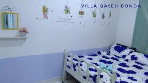 Postel nebo postele na pokoji v ubytování Villa Qaseh Bonda