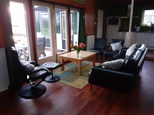a living room with couches and a table and chairs at vakantiehuis Warder in Warder