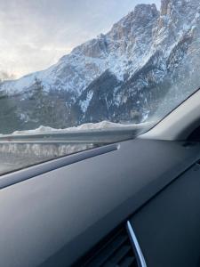 a view of a snow covered mountain from a car at Appartamento Alpe di Siusi in Alpe di Siusi