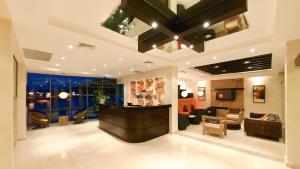 a lobby with a reception desk and a living room at The Beach House in Panama City