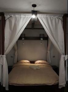 a bedroom with a bed with a canopy at Tara Bridge Castle in Žabljak