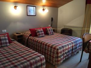 Postel nebo postele na pokoji v ubytování Hôtel Bellachat