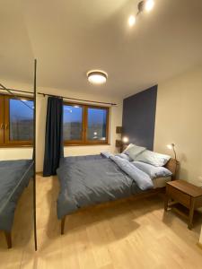a bedroom with a large bed and a table at Panorama Home Valča in Valča