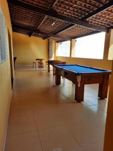 a room with two ping pong tables in it at Cantinho da Felicidade in Praia do Frances