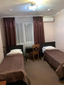 a hotel room with two beds and a desk at Riviera in Klesiv