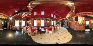 a dining room with red chairs and a red ceiling at Le Каприз in Khmelnytskyi
