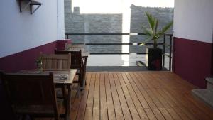 a restaurant with a table and chairs and a balcony at Chill Inn Hostel in Mendoza +30 photos