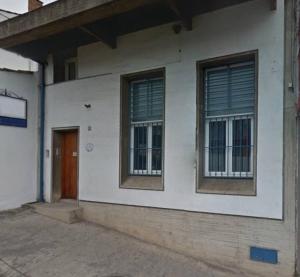 a white building with two windows and a door at La Mariquinta - Residencias in Xalapa +1 photo