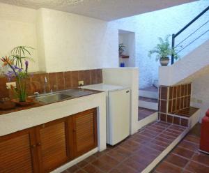 a kitchen with a sink and a counter top at La Mariquinta - Residencias in Xalapa